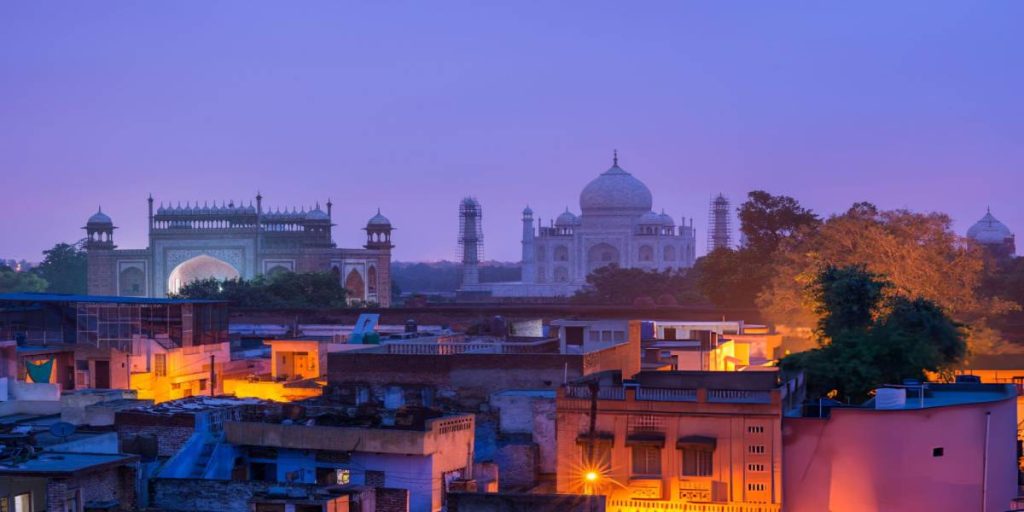 Agra Travel Guide: Must see spots and things to do 7 A mesmerizing view of the Taj Mahal at twilight, as seen from a rooftop in Agra, a highlight of our India Group Tour under the Agra Trip Package