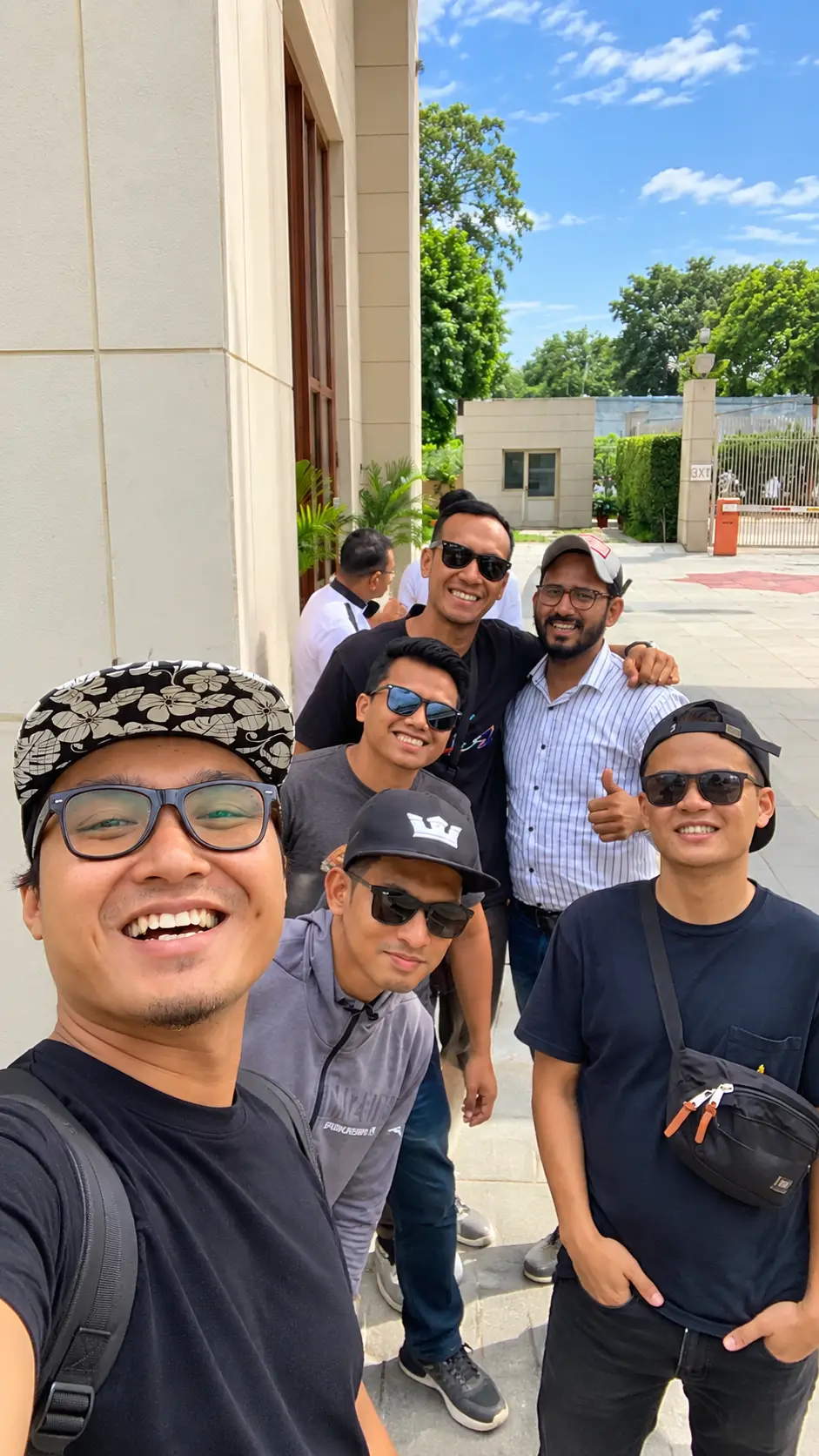 Group of tourists taking a selfie with their tour guide during a visit to Agra, India.