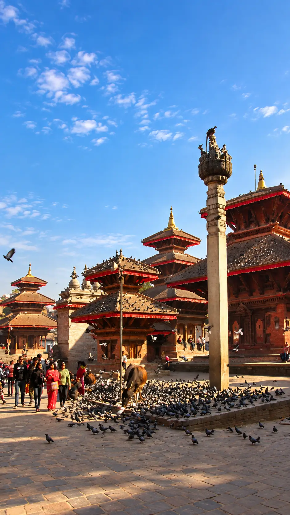 Traditional pagoda temples and a busy courtyard at Kathmandu Durbar Square in Nepal.