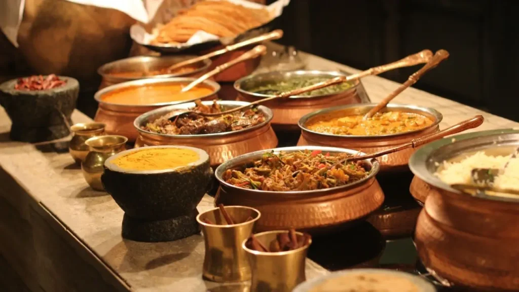 Traditional Indian dishes served in copper pots with rice, curries, vegetables, and spices, showcasing the rich flavors and culinary heritage of Indian cuisine.
