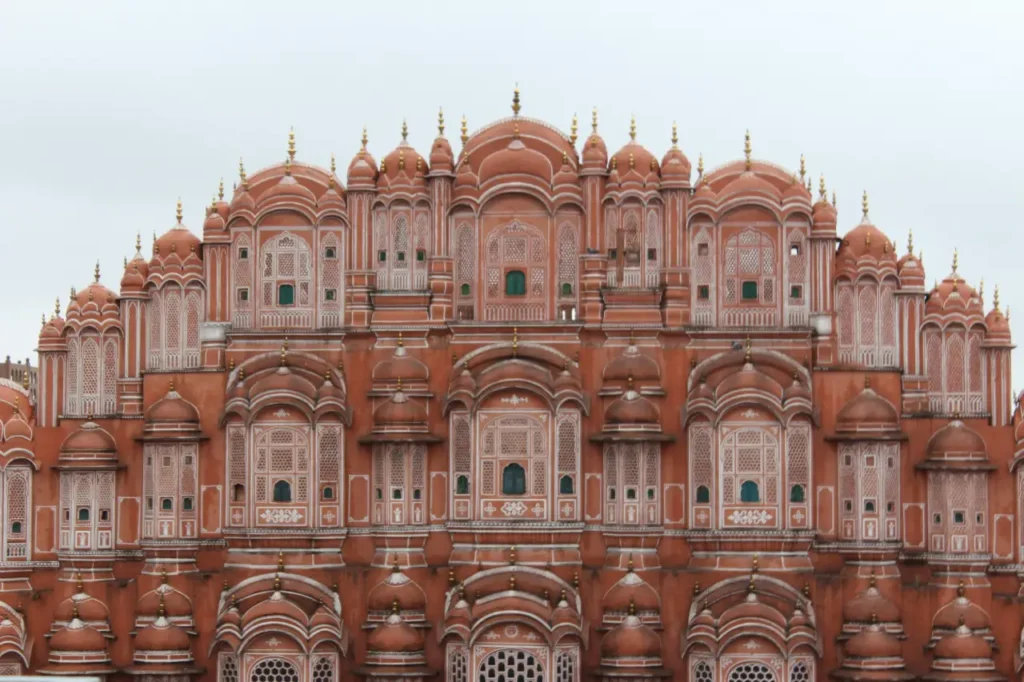 Front view of Hawa Mahal (Palace of Winds) in Jaipur, Rajasthan, featuring its iconic pink sandstone façade and intricate windows.