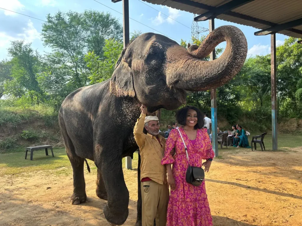 Tourist posing with an elephant and its mahout at an elephant sanctuary in Jaipur, Rajasthan, India.