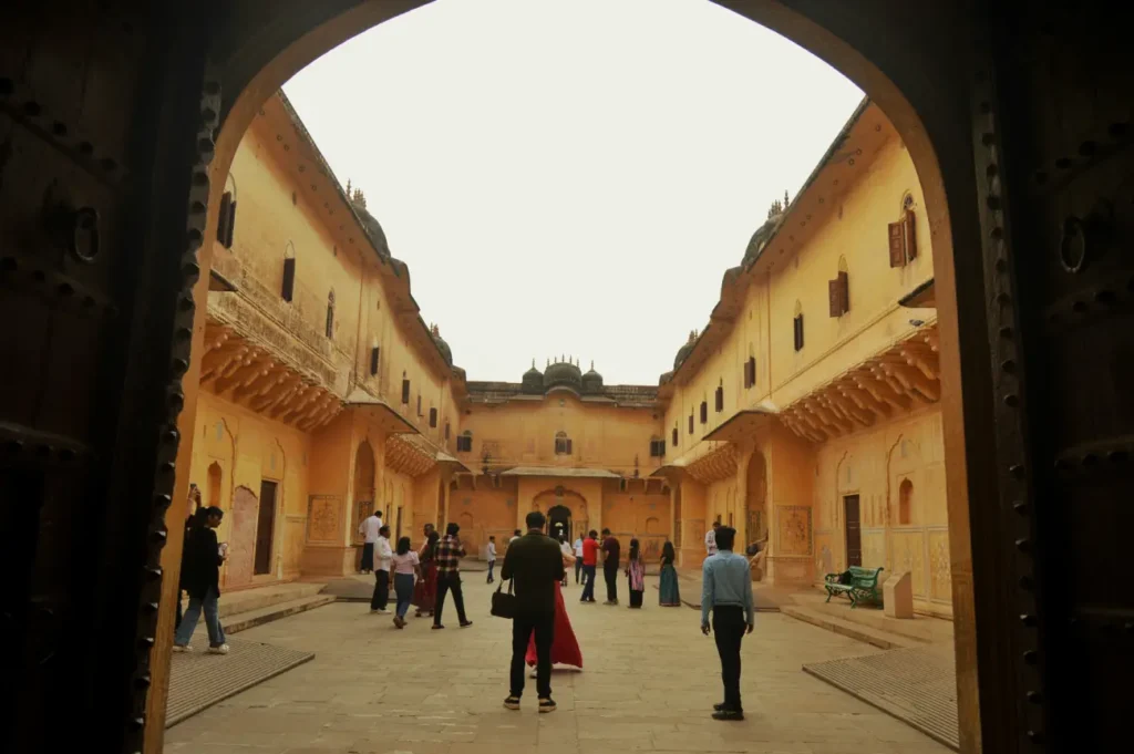 Visitors exploring the historic courtyard inside Nahargarh Fort in Jaipur, Rajasthan, India.